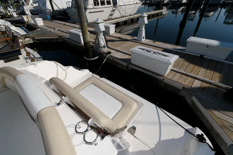 Slide: The Image of 2012 Sea Ray 330 Sundancer docked at marina, showcasing seating and deck area. - 7