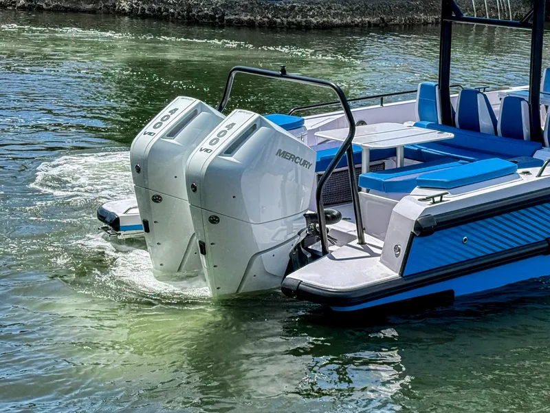 Slide: The Image of 2025 Axopar 37 Sun Top BRABUS Trim with dual Mercury 400 engines on water. - 5