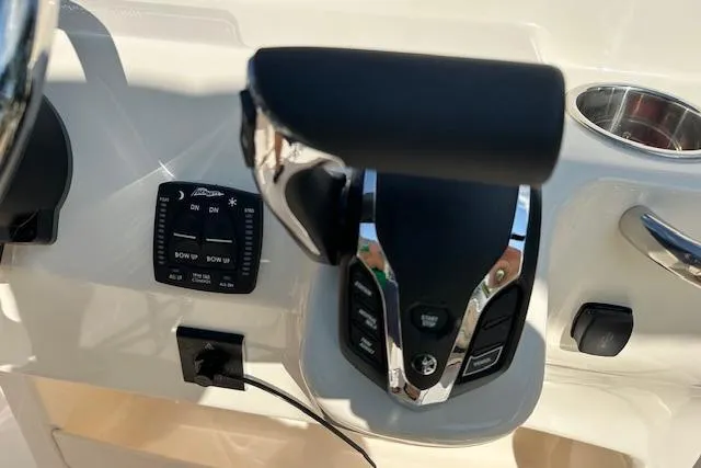 Slide: The Image of 2026 Grady-White Fisherman 180 boat controls with throttle and trim panel. - 11