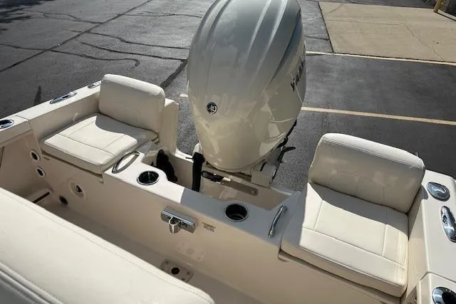 Slide: The Image of 2026 Grady-White Fisherman 180 boat interior with cushioned seating and outboard motor. - 13