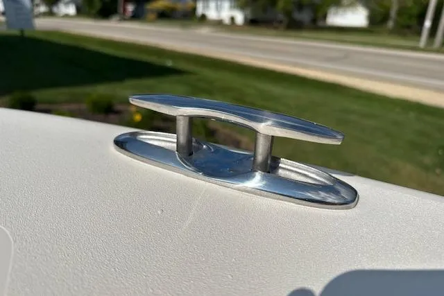 Slide: The Image of 2026 Grady-White Fisherman 180 boat cleat in sunlight, near a road. - 18