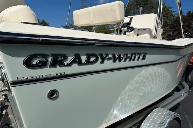 Slide: The Image of 2026 Grady-White Fisherman 180 boat, side view with logo and seating visible. - 2