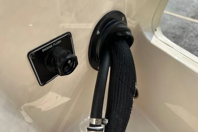 Slide: The Image of 2026 Grady-White Fisherman 180 engine flush port with hose connection. - 27
