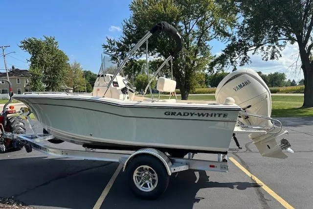Slide: The Image of 2026 Grady-White Fisherman 180 boat on trailer, parked outdoors with Yamaha engine. - 7