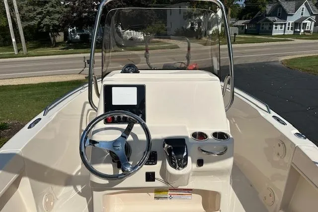 Slide: The Image of 2026 Grady-White Fisherman 180 boat console with steering wheel and controls. - 8