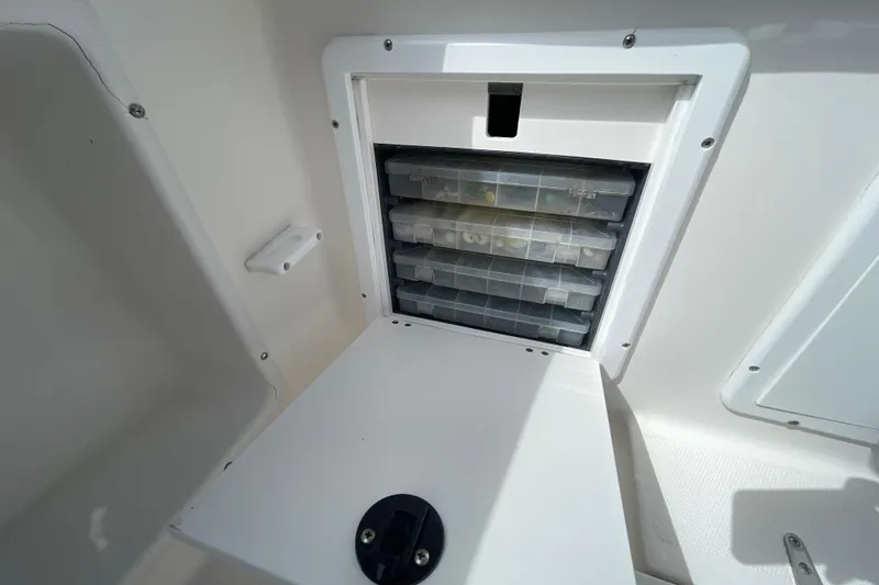 Slide: The Image of Storage compartment with tackle boxes on a 1997 Wellcraft 240 Coastal boat. - 10