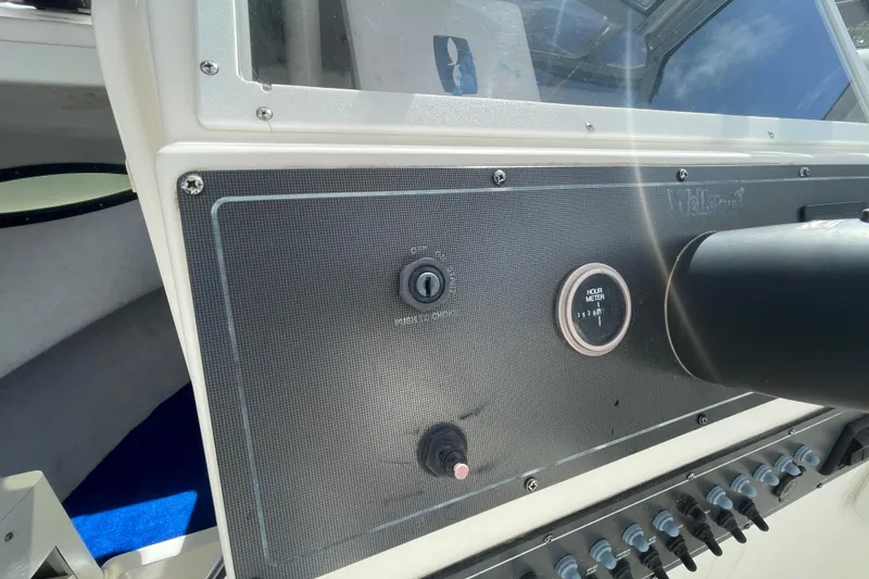 Slide: The Image of 1997 Wellcraft 240 Coastal dashboard with hour meter and ignition switch. - 11
