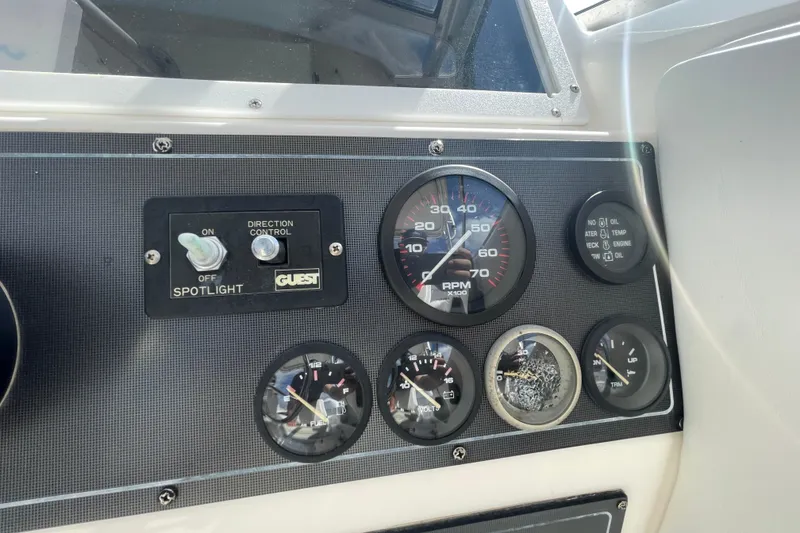 Slide: The Image of Dashboard of a 1997 Wellcraft 240 Coastal boat with gauges and spotlight controls. - 13