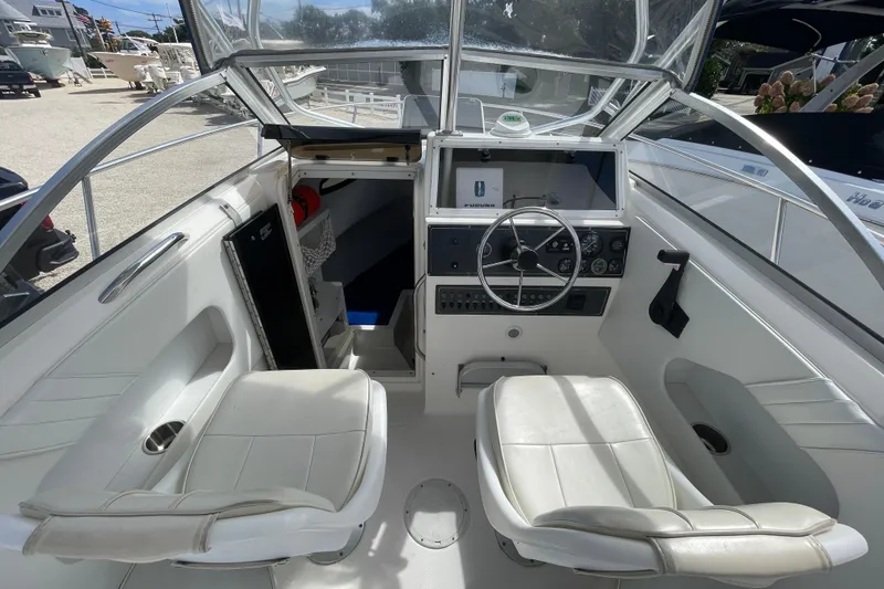 Slide: The Image of 1997 Wellcraft 240 Coastal boat interior with steering wheel and seating. - 15