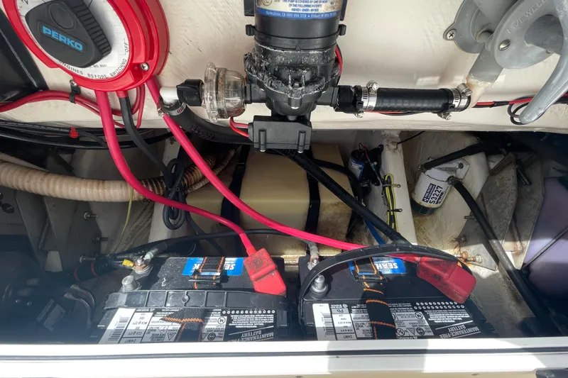 Slide: The Image of 1997 Wellcraft 240 Coastal boat battery compartment with wiring and components. - 18