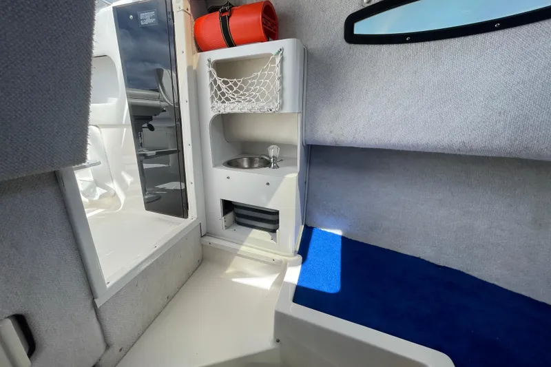 Slide: The Image of Interior of a 1997 Wellcraft 240 Coastal boat with sink and storage. - 19