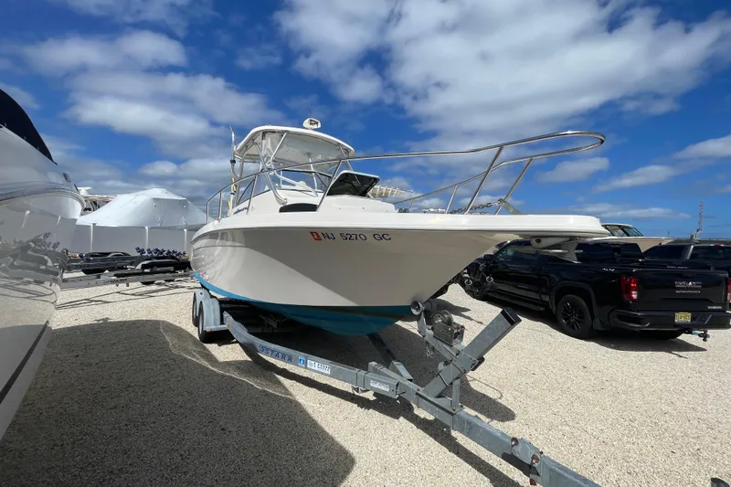Slide: The Image of 1997 Wellcraft 240 Coastal boat on trailer under blue sky. - 2