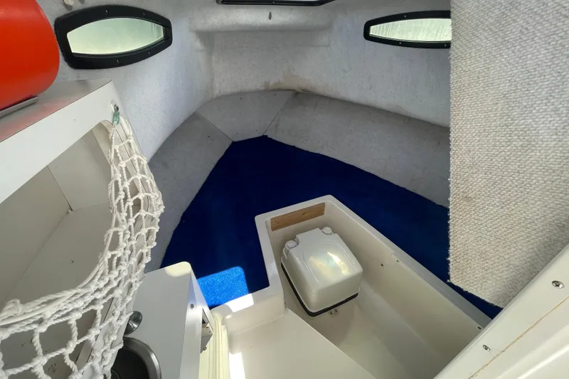 Slide: The Image of Interior cabin of 1997 Wellcraft 240 Coastal boat with blue carpet and storage. - 22