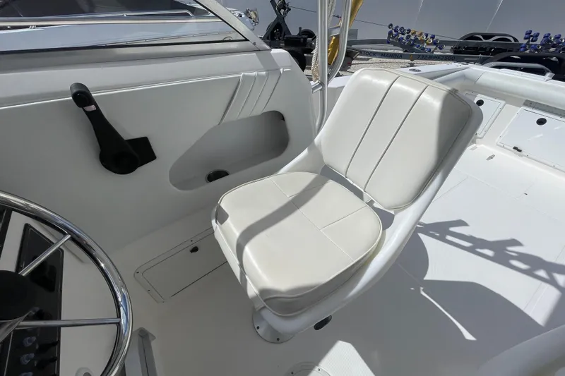 Slide: The Image of 1997 Wellcraft 240 Coastal boat interior with white captain's chair and steering wheel. - 7