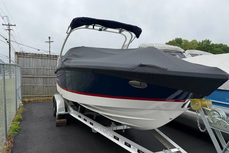Slide: The Image of 2026 Regal LS2 boat on trailer, covered, parked outdoors. - 10