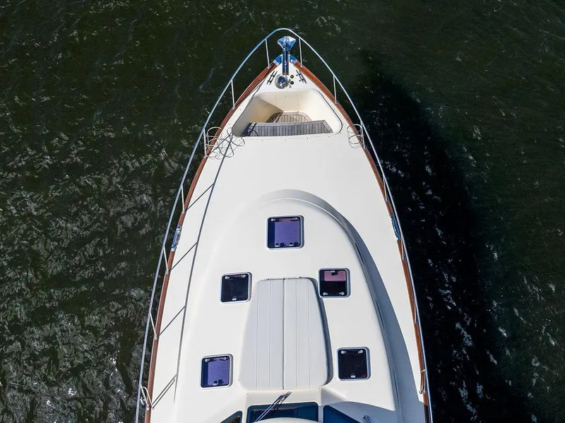 Slide: The Image of 2018 Palm Beach Motor Yachts PB55 Flybridge, aerial view of bow on water. - 20
