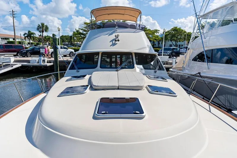 Slide: The Image of 2018 Palm Beach Motor Yachts PB55 Flybridge at marina, showcasing sleek design and luxury features. - 24
