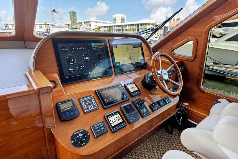 Slide: The Image of Helm of 2018 Palm Beach Motor Yachts PB55 Flybridge with navigation screens and controls. - 37