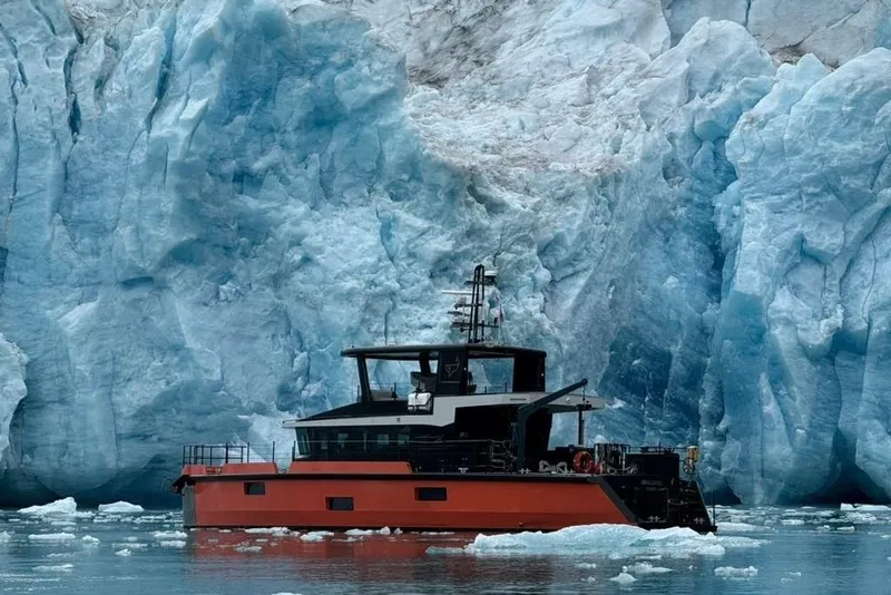 Slide: The Image of 2023 Naval Yachts XPM 78 navigating icy waters near a massive glacier. - 38
