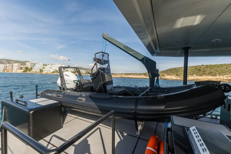 Slide: The Image of RIB boat on deck of 2023 Naval Yachts XPM 78, coastal backdrop. - 5