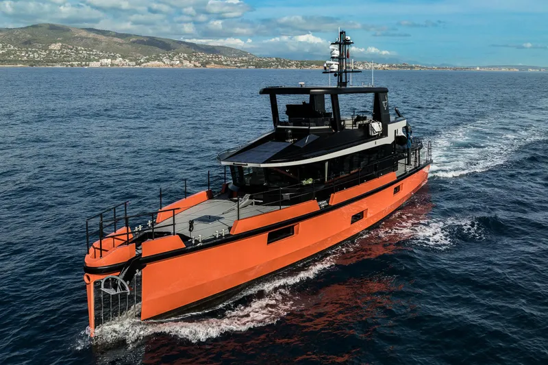 Slide: The Image of 2023 Naval Yachts XPM 78 cruising on open sea with scenic coastal backdrop. - 27