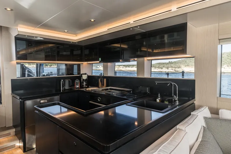 Slide: The Image of Luxurious kitchen interior of 2023 Naval Yachts XPM 78 with sleek black countertops. - 7