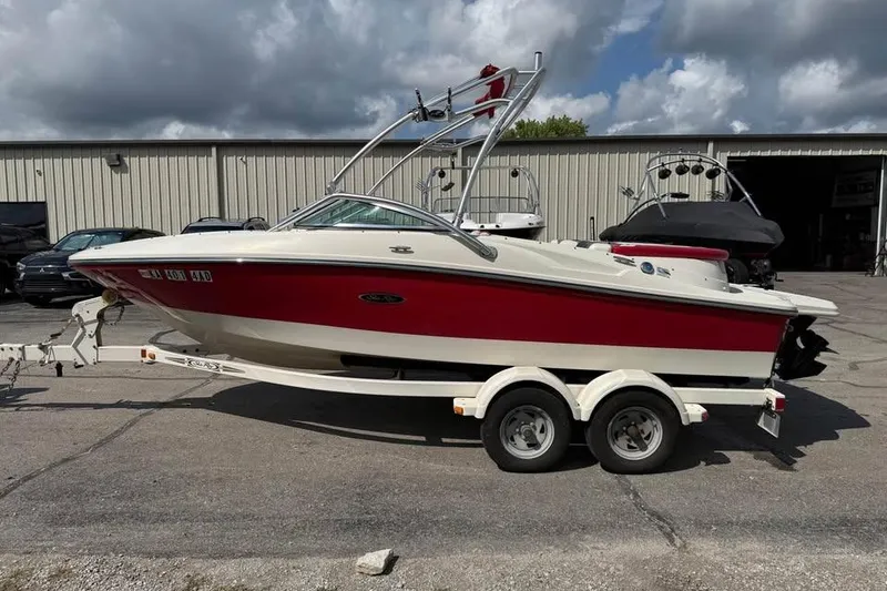 Slide: The Image of 2006 Sea Ray 195 Sport boat on trailer, red and white, parked outdoors. - 4
