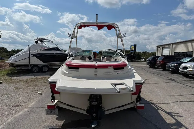 Slide: The Image of 2006 Sea Ray 195 Sport boat parked outdoors under a partly cloudy sky. - 5