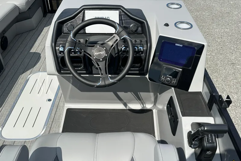Slide: The Image of 2025 Bentley Pontoons 223 Elite Swingback dashboard with steering wheel and navigation system. - 10