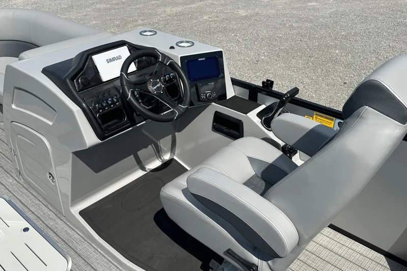 Slide: The Image of 2025 Bentley Pontoons 223 Elite Swingback helm with modern controls and comfortable seating. - 12
