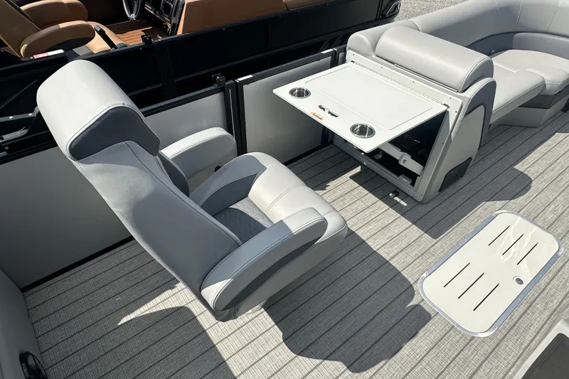 Slide: The Image of 2025 Bentley Pontoons 223 Elite Swingback interior with luxurious seating and foldable table. - 14