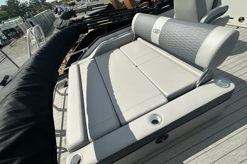 Slide: The Image of 2025 Bentley Pontoons 223 Elite Swingback with luxurious seating and cup holders on deck. - 18
