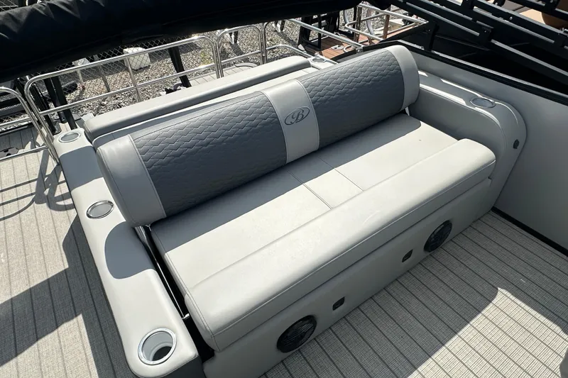 Slide: The Image of 2025 Bentley Pontoons 223 Elite Swingback seating with quilted upholstery and integrated cup holders. - 21