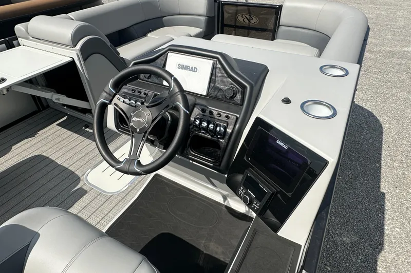 Slide: The Image of 2025 Bentley Pontoons 223 Elite Swingback interior with steering wheel and control panel. - 6