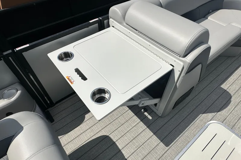 Slide: The Image of 2025 Bentley Pontoons 223 Elite Swingback interior with foldable table and cup holders. - 7