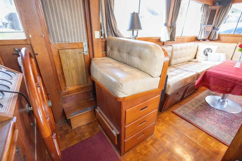 Slide: The Image of Interior of 1985 Grand Banks 42 Classic yacht with wood finish and leather seating. - 19