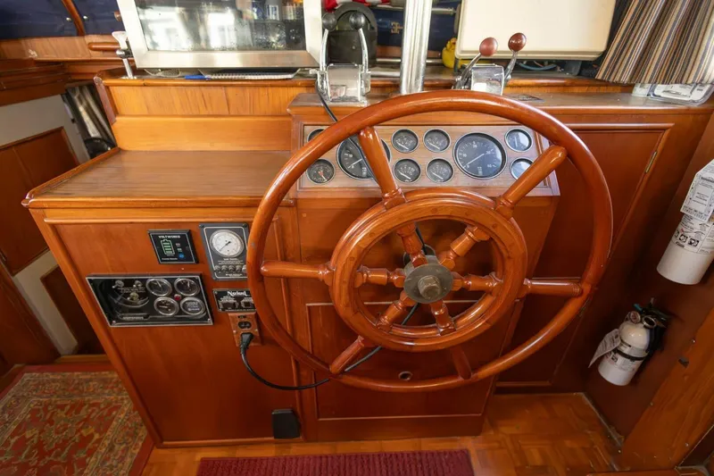 Slide: The Image of 1985 Grand Banks 42 Classic helm with wooden wheel and instrument panel. - 20