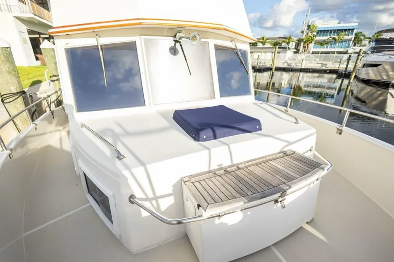 Slide: The Image of 1985 Grand Banks 42 Classic yacht deck with seating, docked at marina. - 24