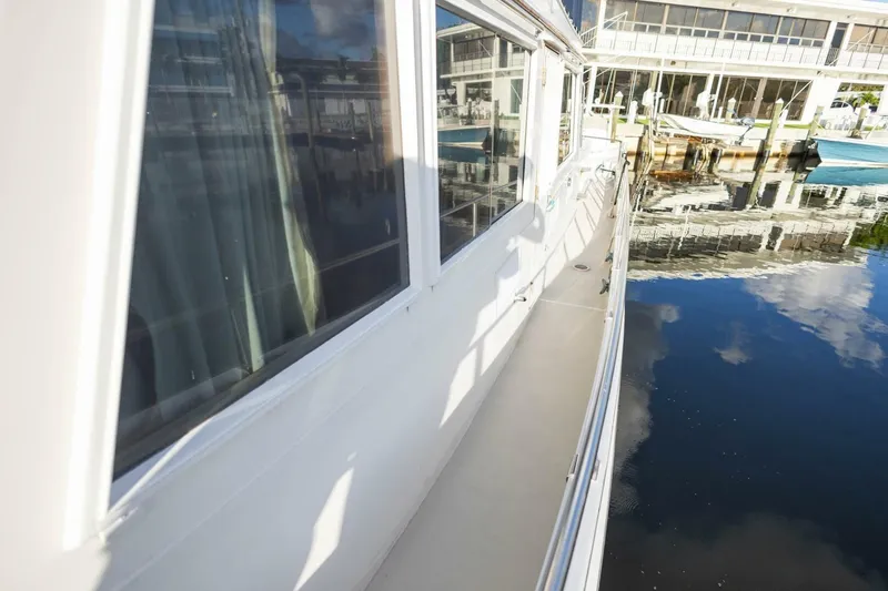 Slide: The Image of 1985 Grand Banks 42 Classic yacht docked, reflecting on calm water. - 26