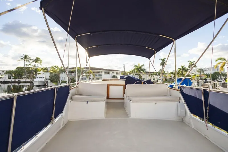 Slide: The Image of Flybridge of 1985 Grand Banks 42 Classic yacht with blue canopy and seating. - 27