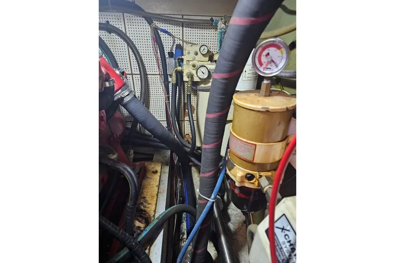 Slide: The Image of Engine room of 1985 Grand Banks 42 Classic with hoses and gauges. - 33