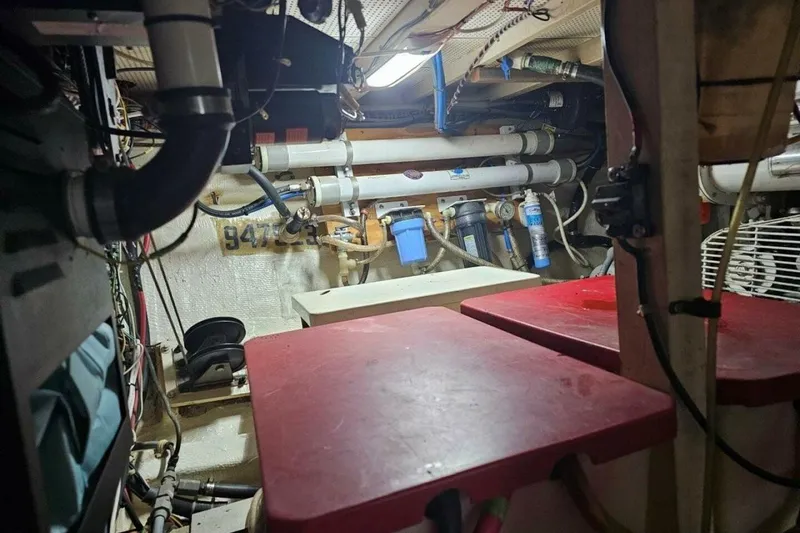 Slide: The Image of Engine room of 1985 Grand Banks 42 Classic yacht, featuring pipes and equipment. - 36