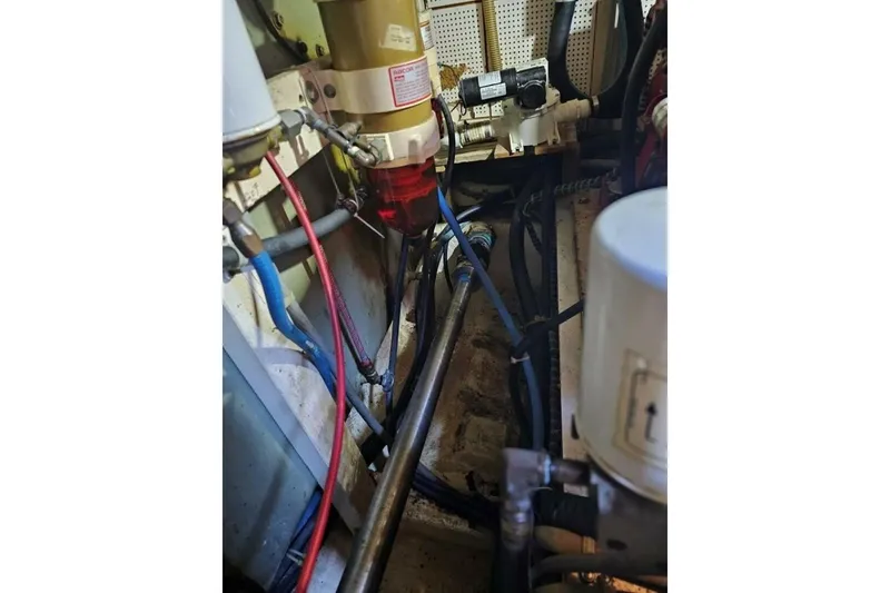 Slide: The Image of Engine room of 1985 Grand Banks 42 Classic with visible pipes and wiring. - 37
