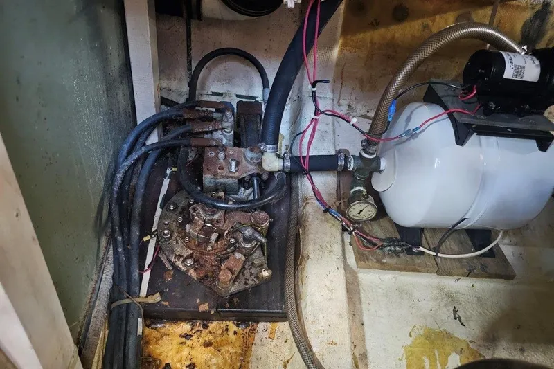 Slide: The Image of Engine compartment of a 1985 Grand Banks 42 Classic boat, showing mechanical components and wiring. - 38