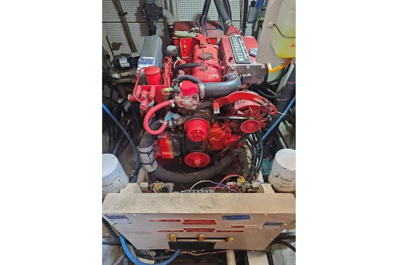 Slide: The Image of Engine room of 1985 Grand Banks 42 Classic with red Westerbeke engine. - 41