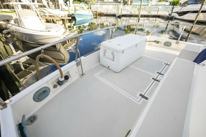 Slide: The Image of Spacious deck of 1985 Grand Banks 42 Classic yacht with cooler, docked in marina. - 6