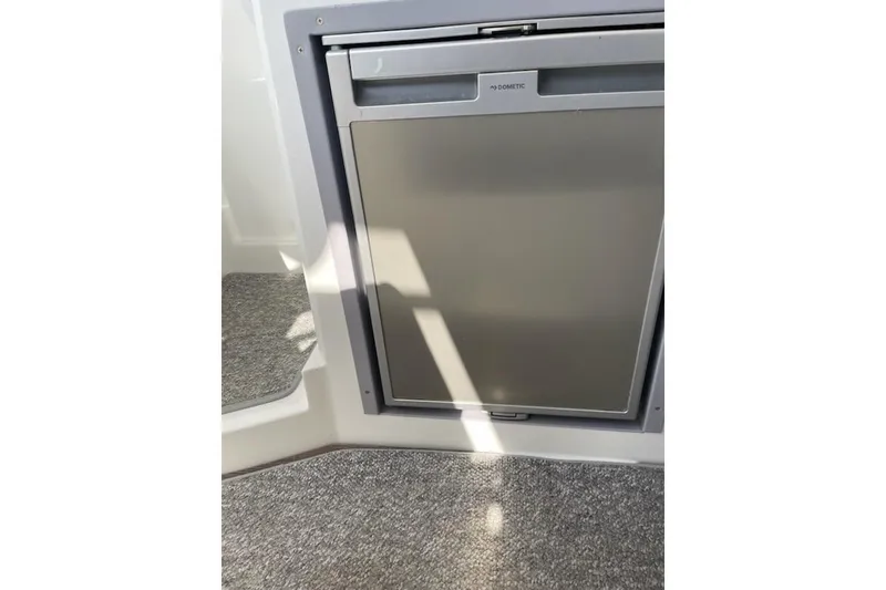 Slide: The Image of Compact refrigerator inside 2019 Beneteau Antares 23 boat, featuring a sleek design. - 10