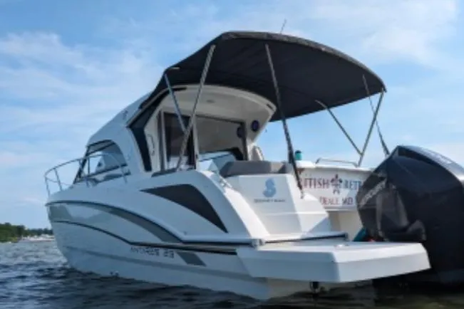 Slide: The Image of 2019 Beneteau Antares 23 boat with canopy, docked on a sunny day. - 5