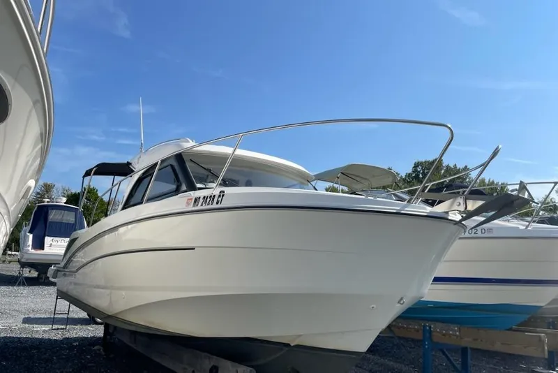 Slide: The Image of 2019 Beneteau Antares 23 boat on display under clear blue sky. - 6