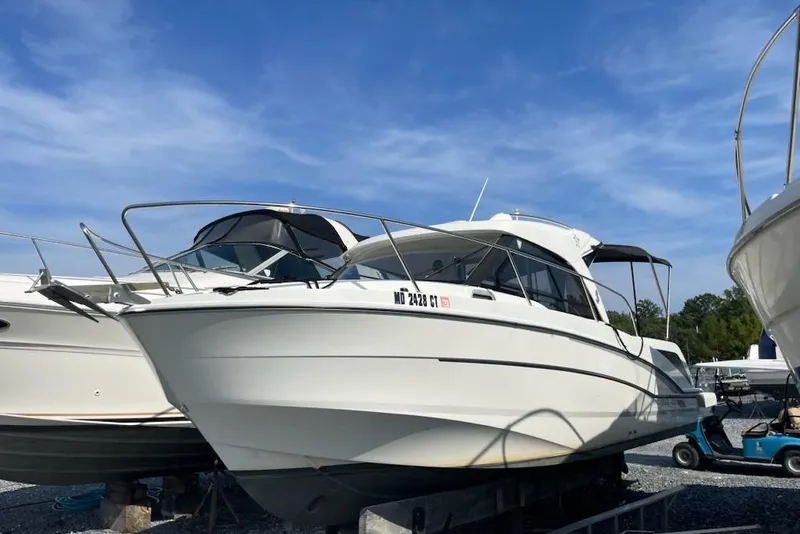 Slide: The Image of 2019 Beneteau Antares 23 boat on display under a clear blue sky. - 7